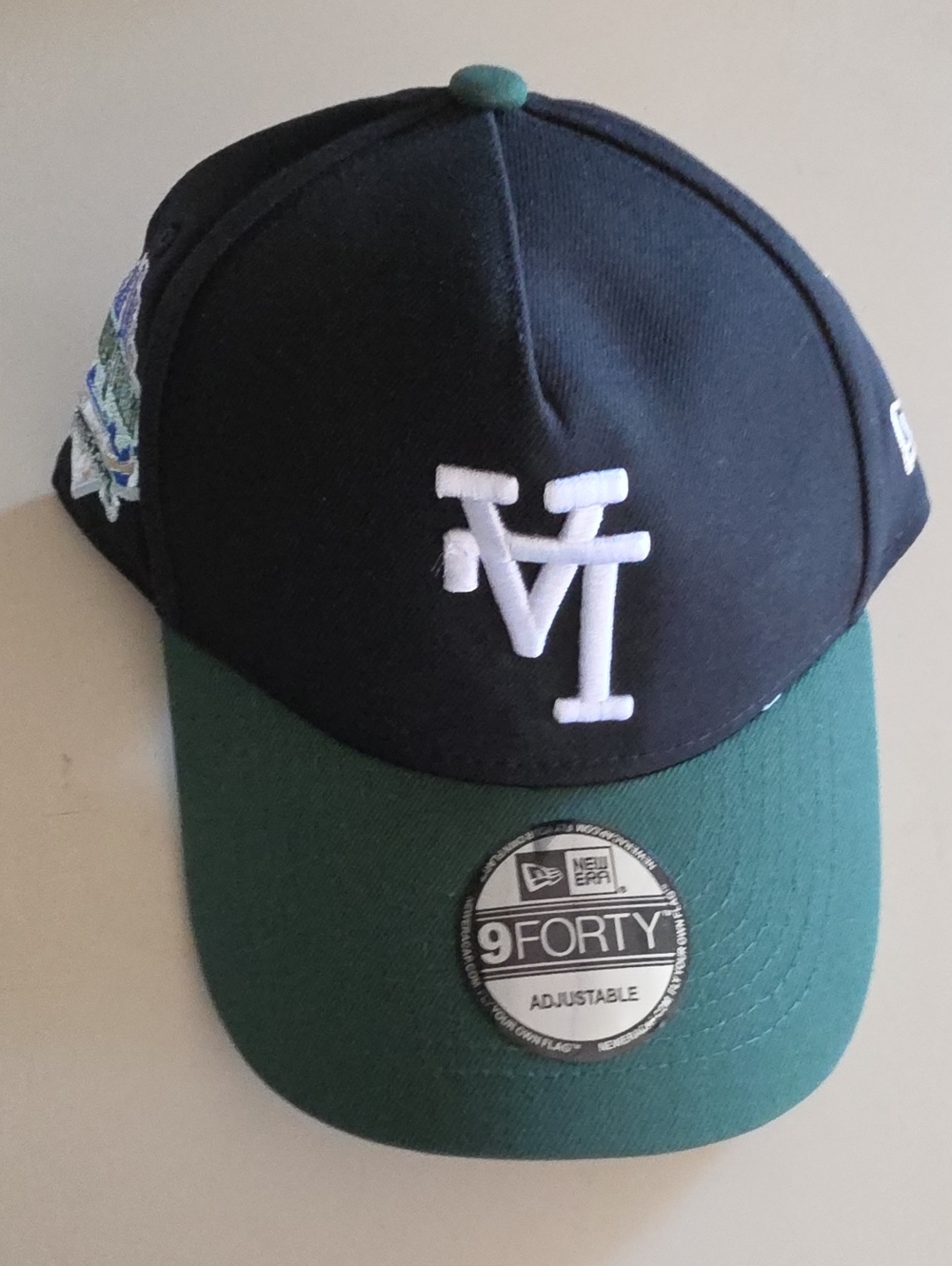 New Era Black and Green 9FORTY Baseball Cap with White Logo